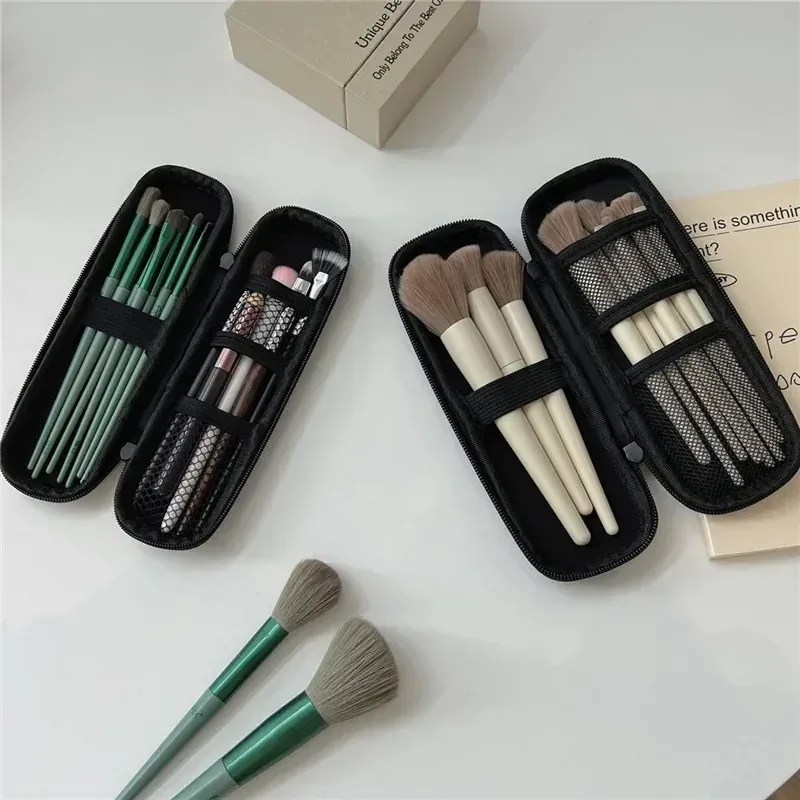 Black zip makeup brush cases with brushes secured under elastic bands and mesh pockets
